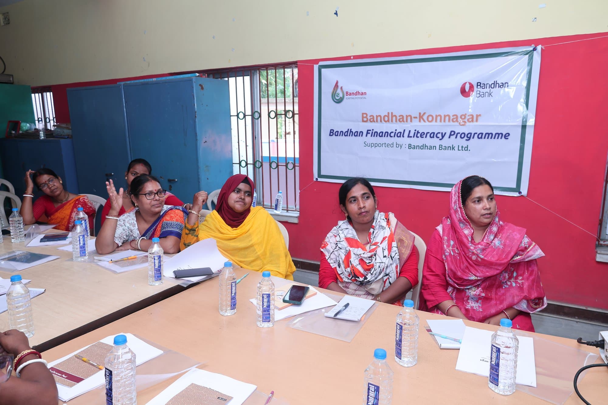 A row of participants taking notes during the session