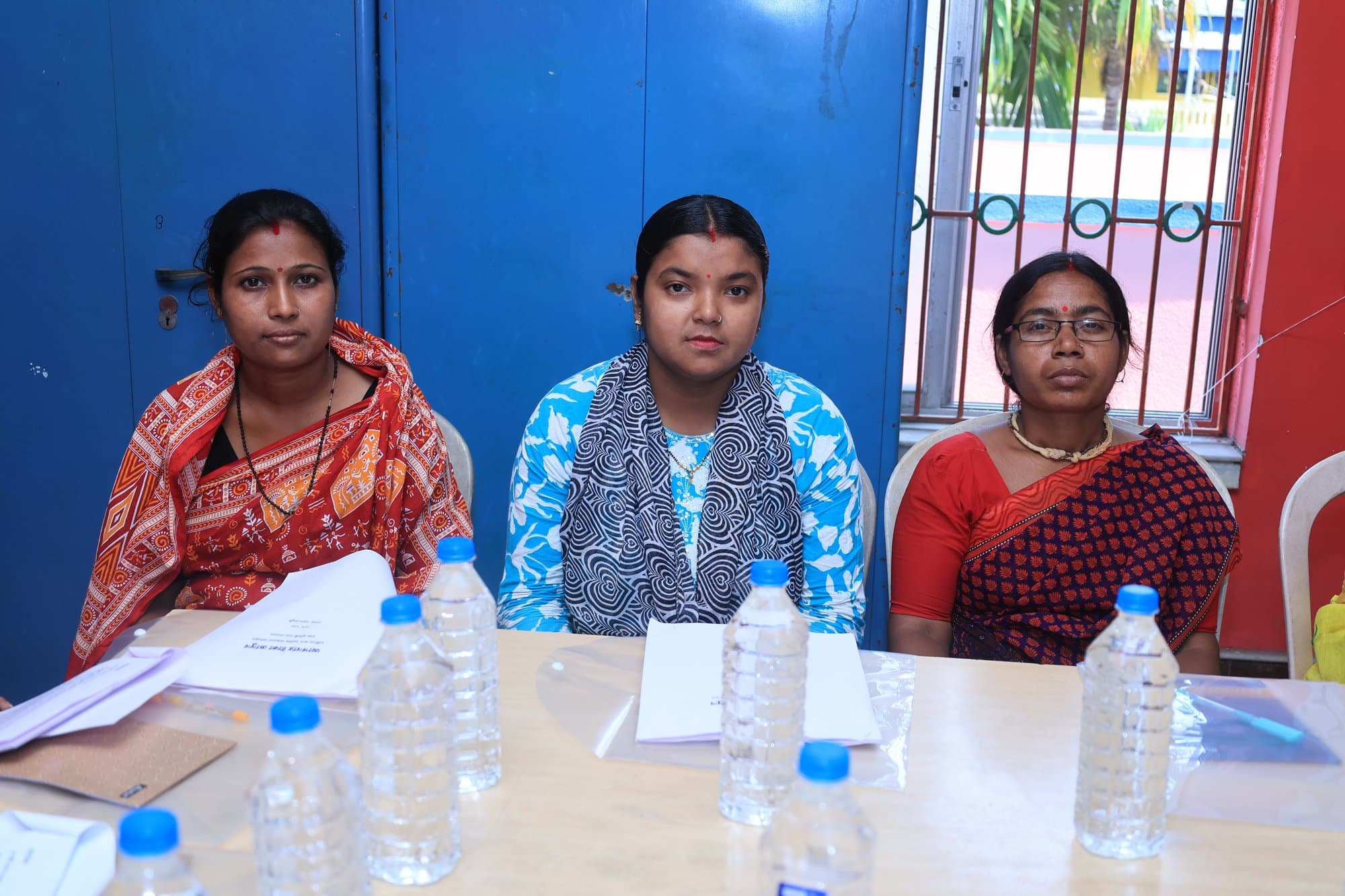 Three participants seated together at the workshop