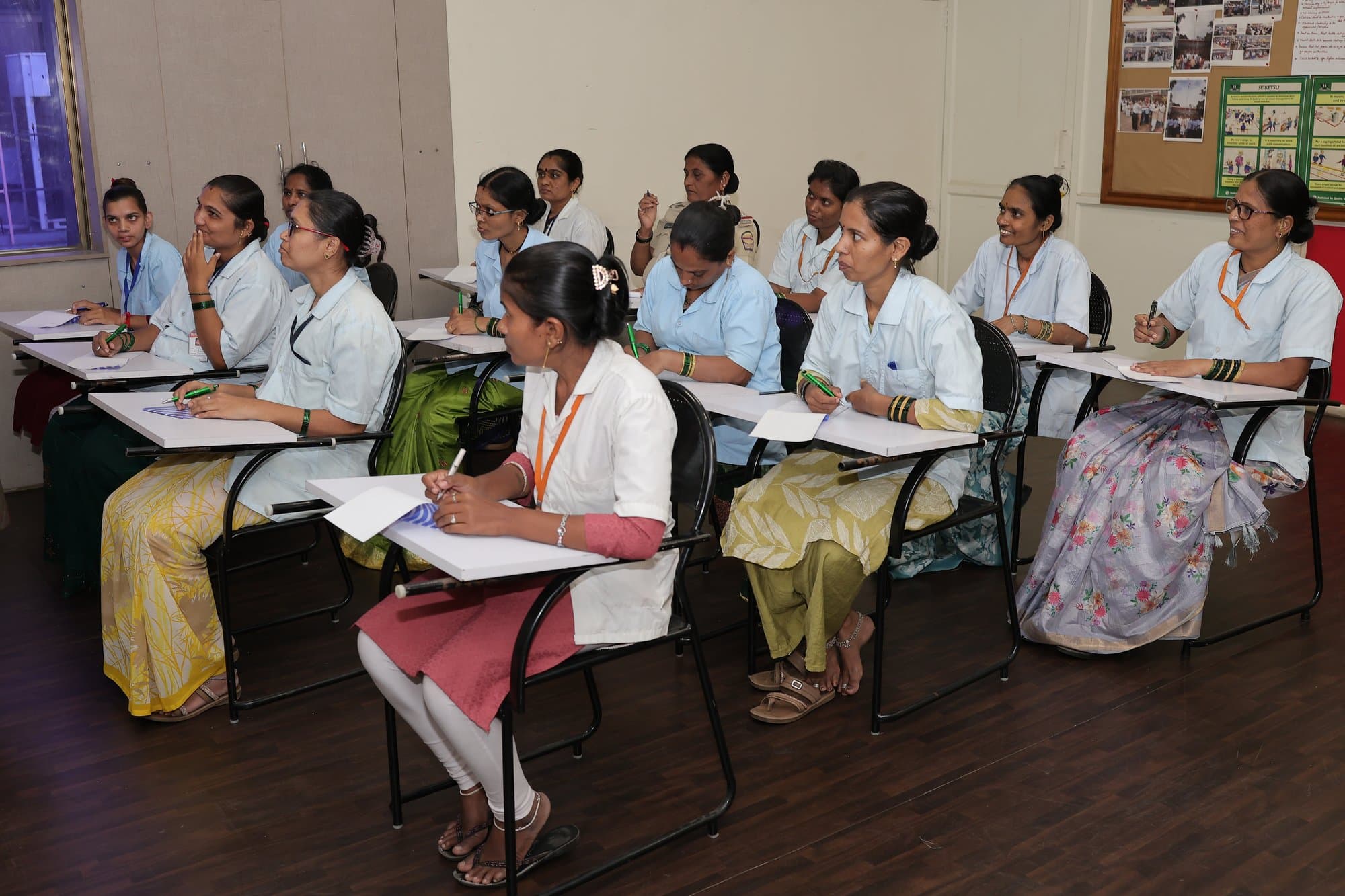 Women at their desks working through a module at Indo Count's training centre in Kolhapur