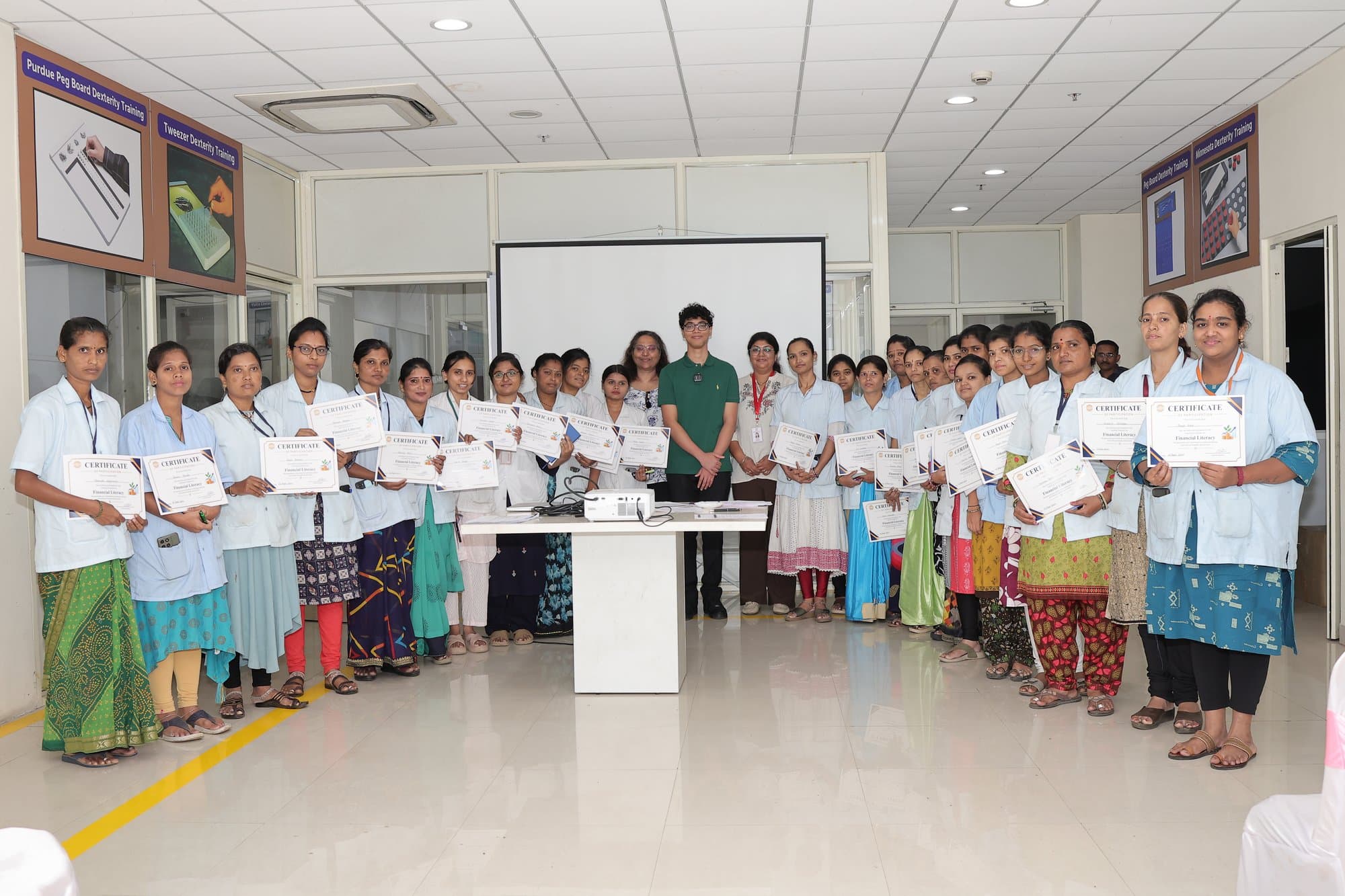 A group of participants holding their certificates at the end of a workshop in Kolhapur