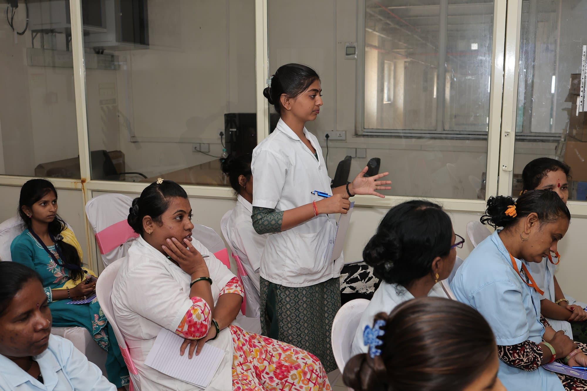 A participant standing to ask a question