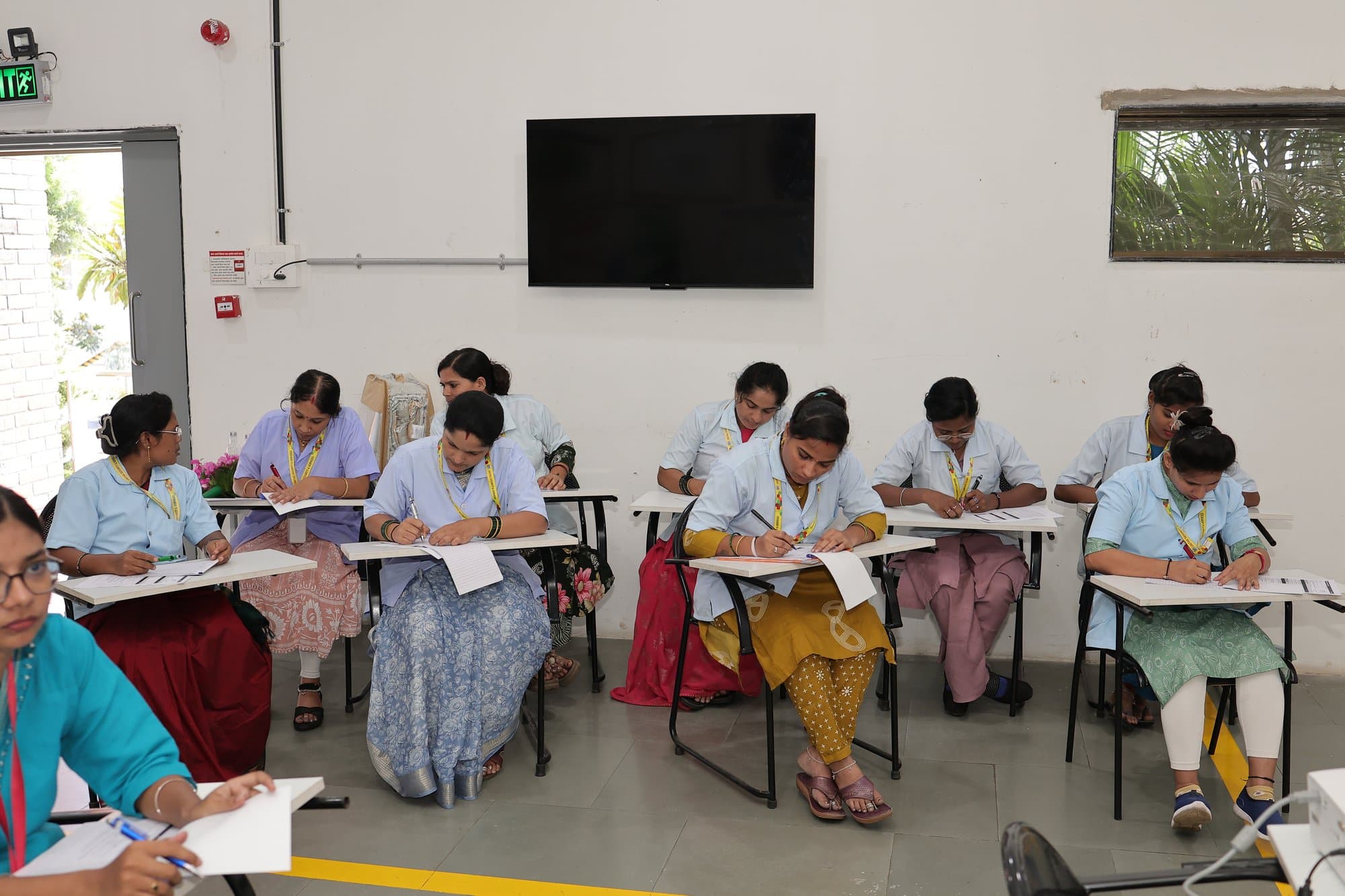 The founder addressing rows of participants seated at desks in Kolhapur