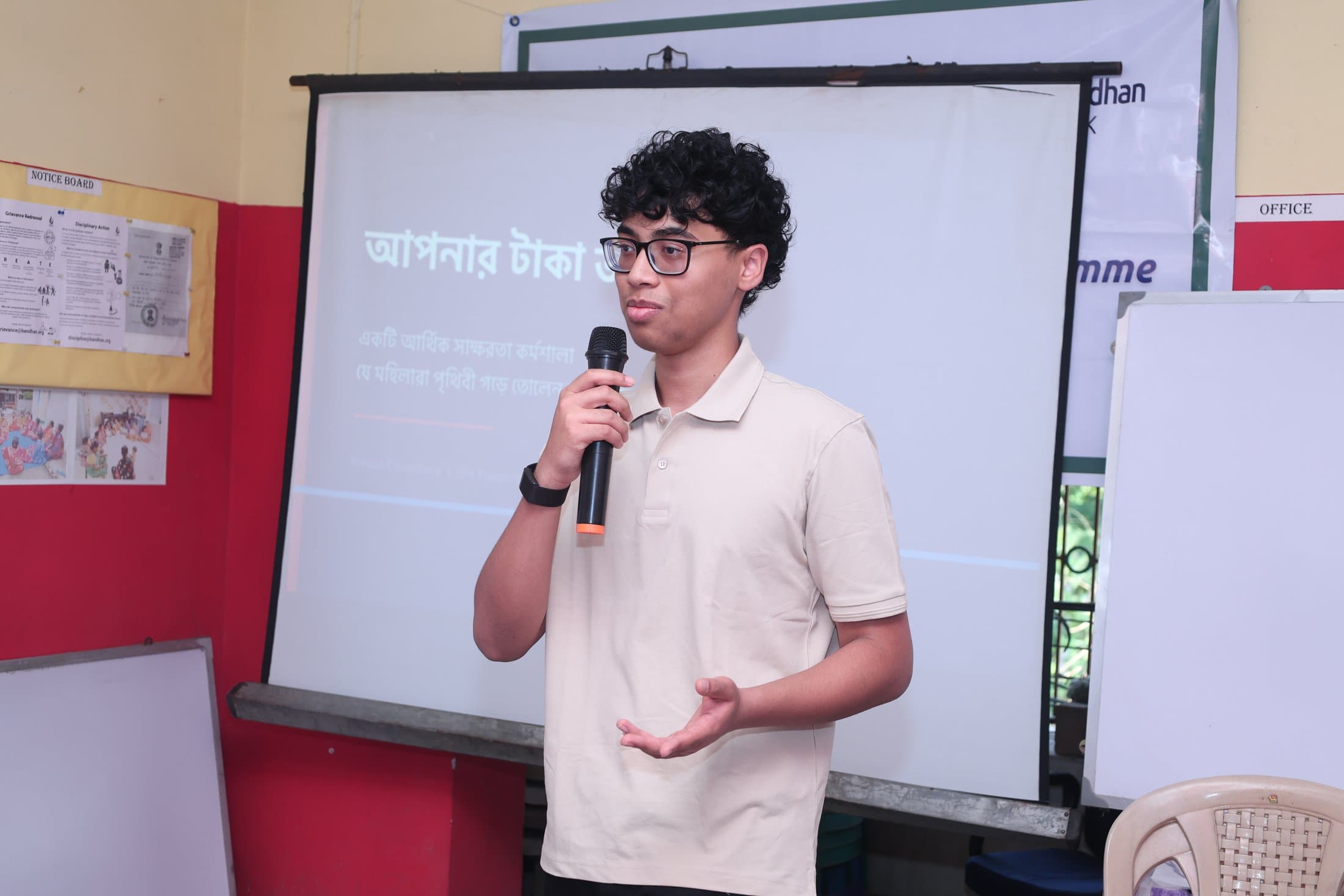 A facilitator presenting the Knowing Your Money curriculum on screen